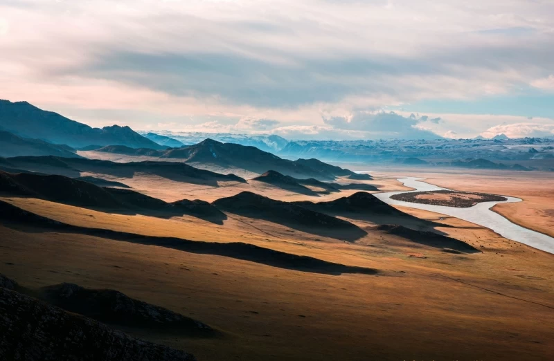 Brown Mountains Near Body Of Small Lake Wallpaper