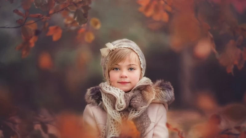 Cute Little Girl Is Wearing Woolen Knitted Scarf And Overcoat In Blur Forest Background HD Cute Wallpaper