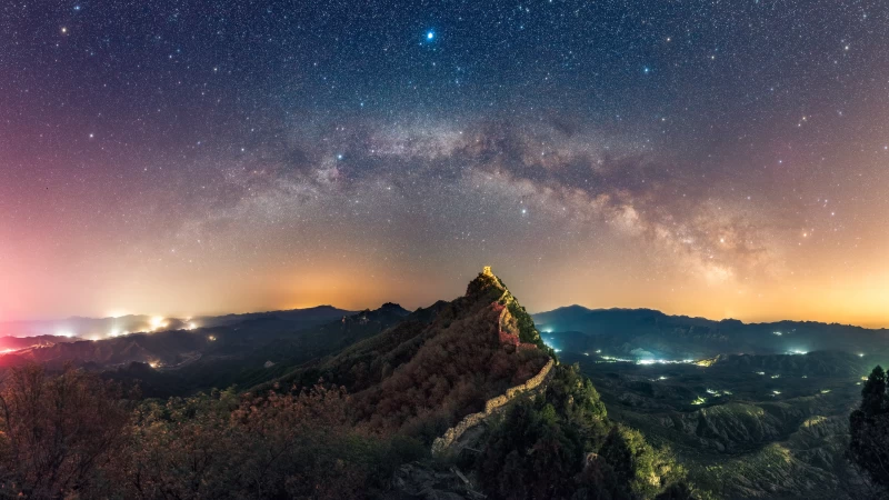 Man Made Great Wall of China at night with sky full of starts Wallpaper