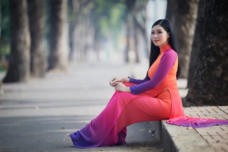 Women Asian girl sitting on bench near tall tree