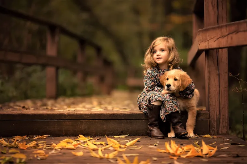 Little Girl With Golden Retriever Puppy Wallpaper