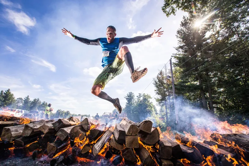 Player Jumping Out Of Burning Woods Wallpaper