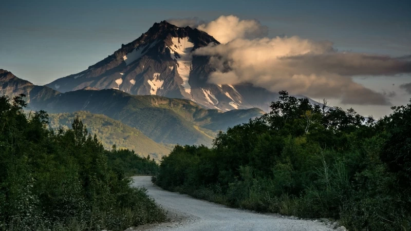 Clouds Covered Mountain Under Gray Concrete Road Between Green Trees 4K HD Nature Wallpaper