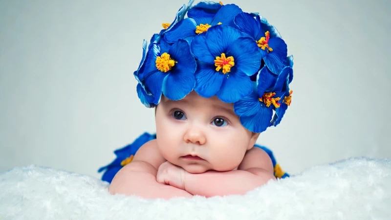 Cute Baby Lying Wearing Vilote Flowers In Head 4K 5K HD Cute Wallpaper