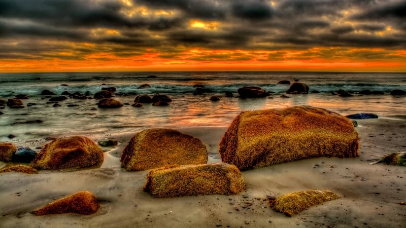 Brown Rocks In Front Of Seashore With Black And Red Clouds 4K HD Nature Wallpaper