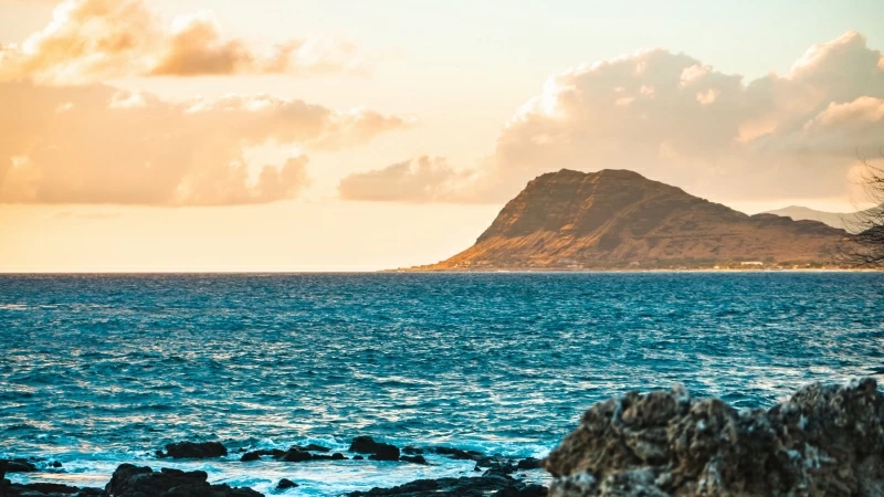 Brown Mountain In Front Of Blue Ocean During Daytime 4K HD Nature Wallpaper