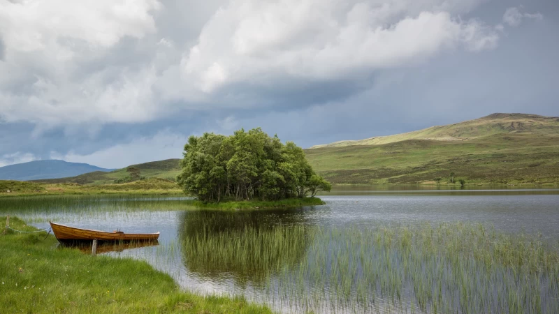 Boat On Lake Green Grass Field Trees Reflection On Water Under White Clouds Blue Sky 4K HD Nature Wallpaper